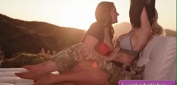  Gorgeous busty lesbian babes Kira Noir, Sinn Sage kiss tender outdoor and lick their big boobs